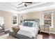 Bright primary bedroom showcases a tray ceiling, plush bed, and sun-filled windows at 3102 Ballet Se Ct, Smyrna, GA 30082