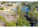 Aerial view of houses alongside a serene lake surrounded by lush greenery and trees at 419 W Wind W Dr, Villa Rica, GA 30180