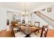Formal dining room with elegant chandelier and staircase to the right at 4397 Challedon Dr, South Fulton, GA 30213