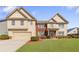 Charming two-story home with a well-manicured lawn and attached two-car garage at 4397 Challedon Dr, South Fulton, GA 30213
