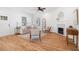 Spacious living room featuring hardwood floors, a fireplace, and abundant natural light at 938 Allene Sw Ave, Atlanta, GA 30310