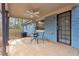 Charming back porch with light blue painted brick, a ceiling fan, and cozy seating, creating an inviting outdoor space at 2336 Mark Trl, Decatur, GA 30032