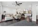 Open concept living area featuring dark hardwood floors, a modern ceiling fan, and seamless flow to the kitchen at 2336 Mark Trl, Decatur, GA 30032