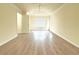 An open, light-filled bedroom with a tray ceiling and hardwood floors at 3060 Scepter Dr, Duluth, GA 30096