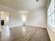 Bright living room featuring hardwood floors, neutral paint, and natural light from the window at 3060 Scepter Dr, Duluth, GA 30096