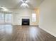 Bright living room with a fireplace, large windows and hardwood flooring at 3060 Scepter Dr, Duluth, GA 30096