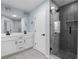 Modern bathroom with dual vanity, black hardware, and a glass-enclosed shower featuring elegant herringbone tiling at 3266 Spicy Cedar Ln, Lithonia, GA 30038