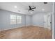 Spacious bedroom featuring a ceiling fan, light hardwood floors, and lots of natural light from the large window at 3266 Spicy Cedar Ln, Lithonia, GA 30038