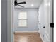 Bright bedroom featuring a ceiling fan, neutral walls, wood floors, and natural light at 3266 Spicy Cedar Ln, Lithonia, GA 30038