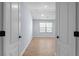 Welcoming bedroom featuring a large window and wood floors, flooded with natural light at 3266 Spicy Cedar Ln, Lithonia, GA 30038