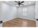 Cozy bedroom with ceiling fan, wood floors, and ample natural light from the window at 3266 Spicy Cedar Ln, Lithonia, GA 30038