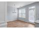 Bright breakfast nook with hardwood floors and a chandelier with backyard views at 3266 Spicy Cedar Ln, Lithonia, GA 30038