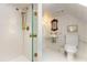 Modern bathroom with white tile, glass shower, and gold fixtures, exuding elegance and luxury at 455 Peachtree Battle Nw Ave, Atlanta, GA 30305