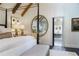 Bright bedroom featuring a luxurious bed, decorative mirror, and attached bathroom at 455 Peachtree Battle Nw Ave, Atlanta, GA 30305