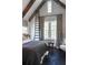 Cozy bedroom featuring exposed wood beams, dark wood floors, and a ladder to reach a small attic window at 455 Peachtree Battle Nw Ave, Atlanta, GA 30305