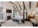 Luxurious bedroom featuring a four-poster bed, fireplace, and vaulted ceilings at 455 Peachtree Battle Nw Ave, Atlanta, GA 30305