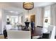 Dining area with a round wood table, seating for six, and views of the living room at 455 Peachtree Battle Nw Ave, Atlanta, GA 30305