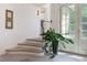 Bright entryway featuring stone steps, slate floors, white walls, and a verdant potted plant at 455 Peachtree Battle Nw Ave, Atlanta, GA 30305