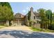 Beautiful home featuring a stone and brick exterior, garage, and manicured front yard at 455 Peachtree Battle Nw Ave, Atlanta, GA 30305