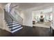 Grand foyer with a winding staircase, hardwood floors, and access to the living room at 455 Peachtree Battle Nw Ave, Atlanta, GA 30305