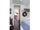 Hallway with dark wood floors, white walls, and black and white art, leading to a dining room at 455 Peachtree Battle Nw Ave, Atlanta, GA 30305