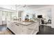 Spacious open concept kitchen with large island, farmhouse sink, and views to living room at 455 Peachtree Battle Nw Ave, Atlanta, GA 30305