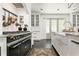 Stylish kitchen featuring a black range, farmhouse sink, and an abundance of storage at 455 Peachtree Battle Nw Ave, Atlanta, GA 30305