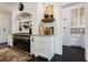 Elegant kitchen featuring painted brick, modern appliances, and decorative shelving at 455 Peachtree Battle Nw Ave, Atlanta, GA 30305