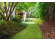 Lush backyard landscaping with a winding pathway, trees, and garden beds at 455 Peachtree Battle Nw Ave, Atlanta, GA 30305