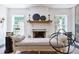 Cozy living room featuring a fireplace, built-in shelving, and bright windows at 455 Peachtree Battle Nw Ave, Atlanta, GA 30305