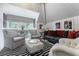 Bright living room with gray upholstered chairs, a black and white rug, and ample natural light at 455 Peachtree Battle Nw Ave, Atlanta, GA 30305