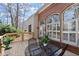 A beautiful back deck has wrought iron table and chairs and a beautiful brick wall as backdrop at 5043 Willeo Estates Dr, Marietta, GA 30068