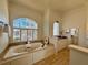 Elegant bathroom with a soaking tub, vanity area, and decorative window, designed for relaxation and comfort at 5043 Willeo Estates Dr, Marietta, GA 30068