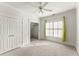 Sunlit bedroom with large closet, green curtains, and soft carpet flooring at 5043 Willeo Estates Dr, Marietta, GA 30068