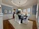 Bright and elegant dining room with wainscoting, a modern chandelier, and ample natural light at 5043 Willeo Estates Dr, Marietta, GA 30068