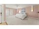 Spacious main bedroom featuring neutral colored walls, white trim, a ceiling fan, and two closets at 5043 Willeo Estates Dr, Marietta, GA 30068