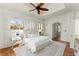 The primary bedroom includes hardwood floors, shuttered windows and a vaulted ceiling with ceiling fan at 5043 Willeo Estates Dr, Marietta, GA 30068