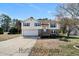 Charming home with a two-car garage, stone accents, and a well-maintained front yard on a clear day at 157 Pat Dr, Powder Springs, GA 30127