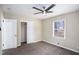 Cozy bedroom features a ceiling fan, neutral walls, and ample natural light from the window at 3173 Canary Ct, Decatur, GA 30032