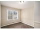 Cozy bedroom featuring paneled walls, plush carpeting, and natural light from the window for a warm and inviting space at 3173 Canary Ct, Decatur, GA 30032