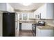 Modern kitchen features white cabinets, granite countertops, and stainless-steel appliances at 3173 Canary Ct, Decatur, GA 30032
