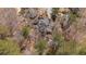 Aerial shot shows the home nestled amongst mature trees and a natural creek on the property at 1458 Sweet Bottom Cir, Marietta, GA 30064