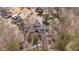 Aerial view shows the home in a residential neighborhood with a creek running behind the property at 1458 Sweet Bottom Cir, Marietta, GA 30064