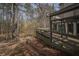 Backyard deck with railing overlooks a serene natural setting and creek at 1458 Sweet Bottom Cir, Marietta, GA 30064
