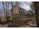 Creek running through backyard with a small retaining wall, deck and lush greenery at 1458 Sweet Bottom Cir, Marietta, GA 30064