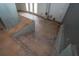 View of basement with concrete stairs, stained floor, and exterior door at 1458 Sweet Bottom Cir, Marietta, GA 30064
