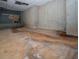 Unfinished basement with concrete floors and walls, showing signs of moisture damage at 1458 Sweet Bottom Cir, Marietta, GA 30064