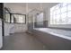 Large, bright bathroom featuring a glass-enclosed shower, jacuzzi tub, and large leaded-glass window at 1458 Sweet Bottom Cir, Marietta, GA 30064