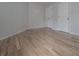 Bedroom with refinished hardwood floors, two doors, and white walls at 1458 Sweet Bottom Cir, Marietta, GA 30064