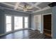Bright bedroom with large windows, hardwood floors, ceiling fan and built-in closet space at 1458 Sweet Bottom Cir, Marietta, GA 30064